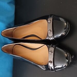 Black Coach flats, with metal detailing on the toes.